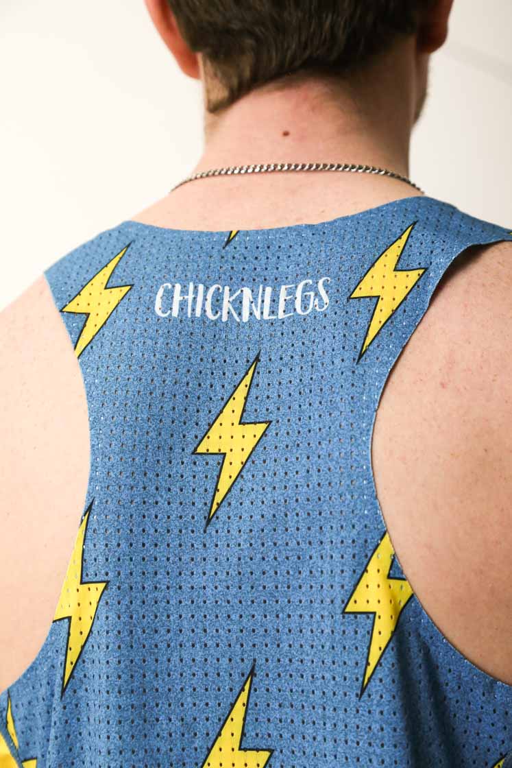Closeup view of the ChicknLegs logo on the mesh panel backing of the blue bolts singlet.