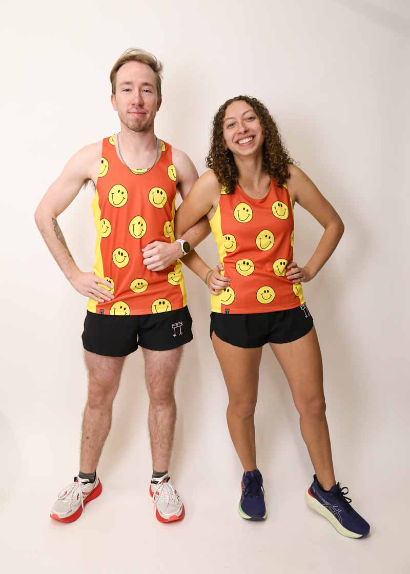 Runners wearing the men's and women's smiley face performance singlets from ChicknLegs.