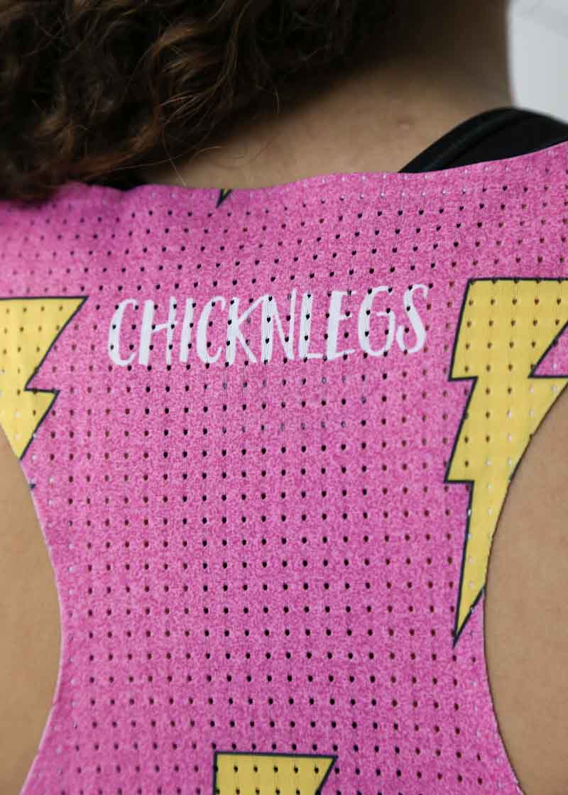 Closeup view of the back mesh paneling on our women's pink bolts running singlet.