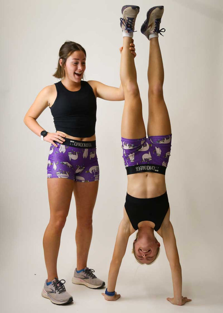 Runner doing a handstand in the women's 3 inch compression sloth shorts.