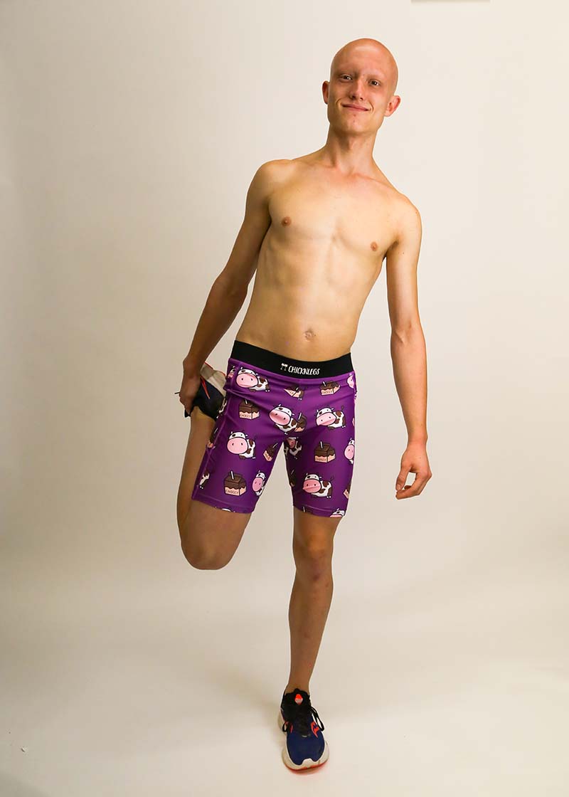 Runner stretching while wearing the men's 8 inch choccy cows compression half tights.
