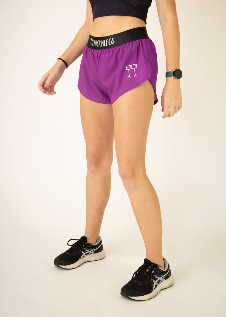 Runner is wearing ChicknLegs in the women's 1.5 in split running shorts in the deep purple design. The print is a solid color that matches well with Choccy Cow design.