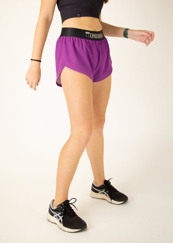 Runner is wearing ChicknLegs in the women's 1.5 in split running shorts in the deep purple design. The print is a solid color that matches well with Choccy Cow design.
