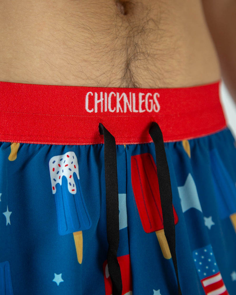 A close up shot is shown of the drawstrings untied together inside the waistband. USA Popsicles are ChicknLeg's men's 2 in drawstring in the split running shorts.