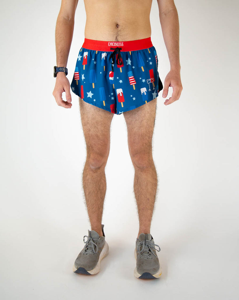 Runner is wearing ChicknLegs in the men's 2 in drawstring split running shorts in the USA Popsicle design. The print has fun vibrant red, white and blue all over it.