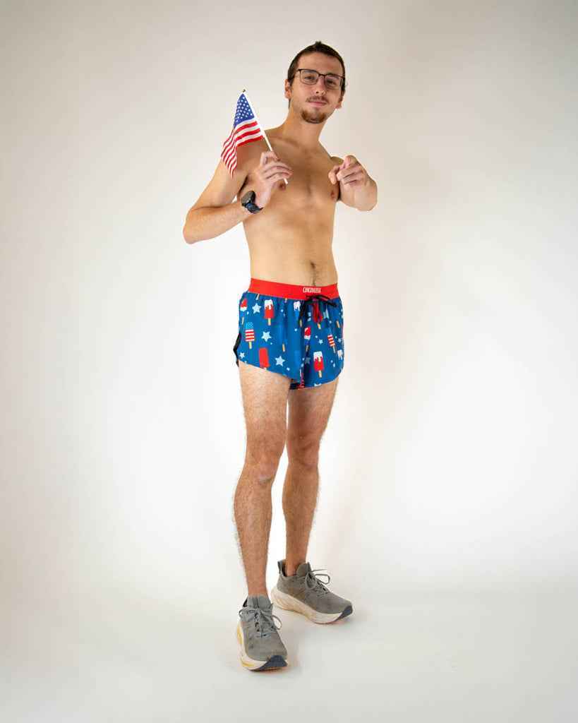 Runner is wearing ChicknLegs in the men's 2 in drawstring that are split running shorts with the USA Popsicle design that has red, white and blue all over it. Great for 4th of july and repping that American Pride.