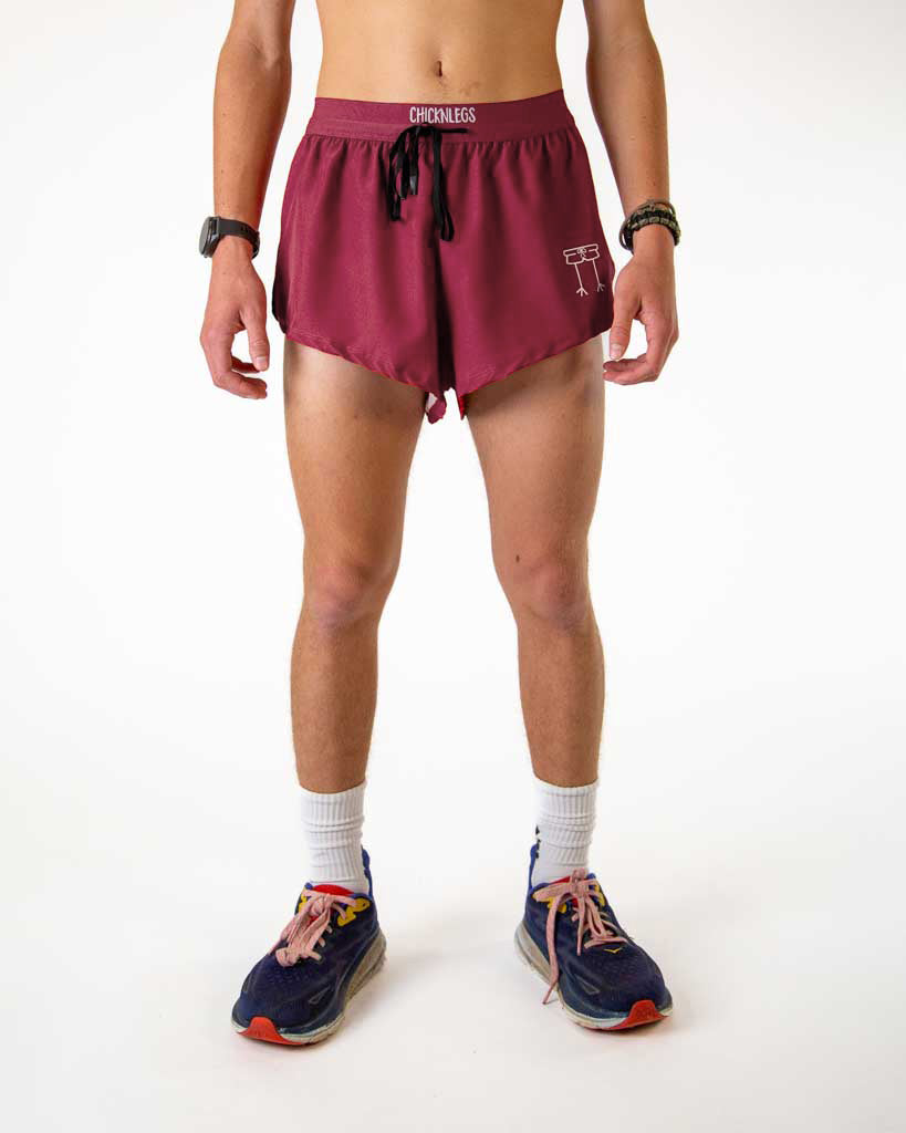 Front view of ChicknLegs Men's 2-inch DS split running shorts in the maroon solid color, featuring a soft elastic drawstring waistband for a smooth, secure fit and black mesh liner for coverage. 