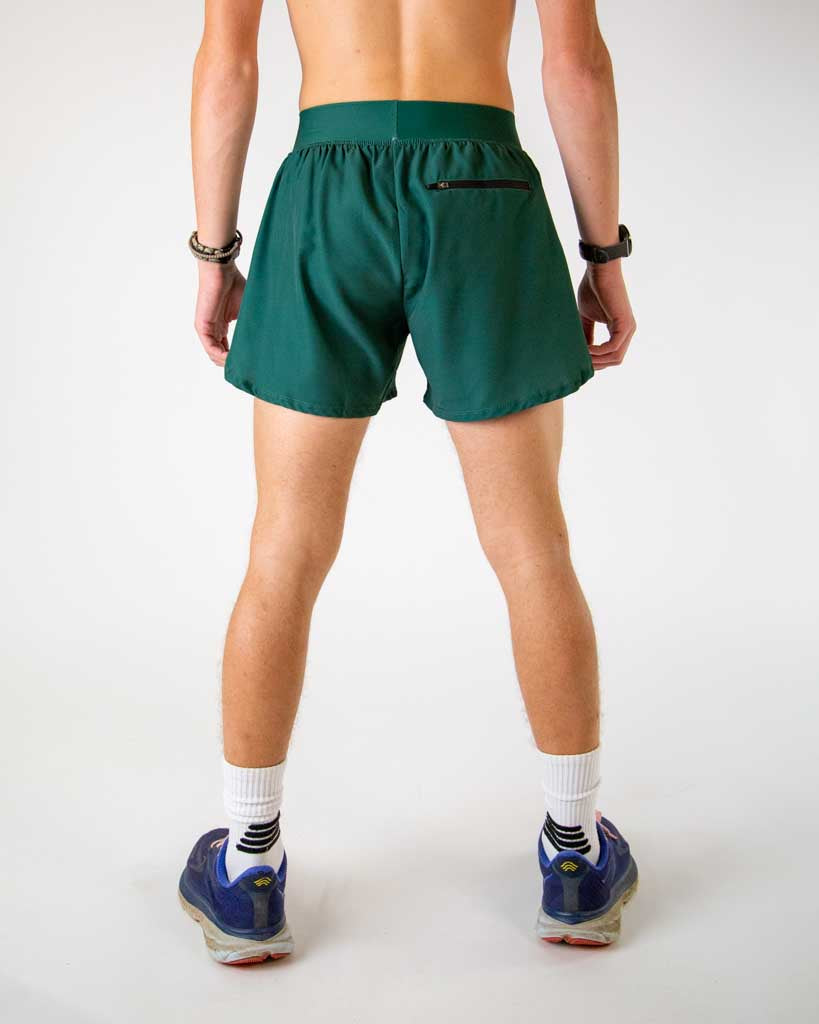 Back view of ChicknLegs men’s 4-inch split running shorts in solid forest green pattern, showing elastic waistband and breathable liner with back zipper pocket.