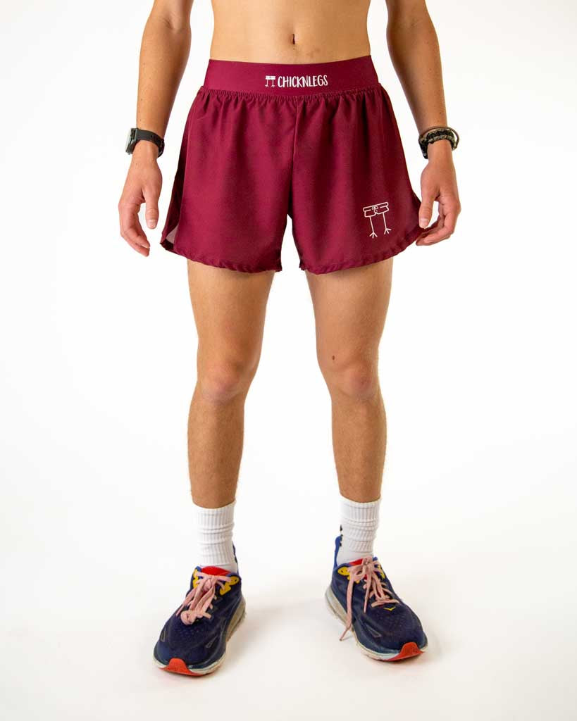 Front view of ChicknLegs men’s 4-inch split running shorts elastic waistband, breathable liner, solid maroon pattern.