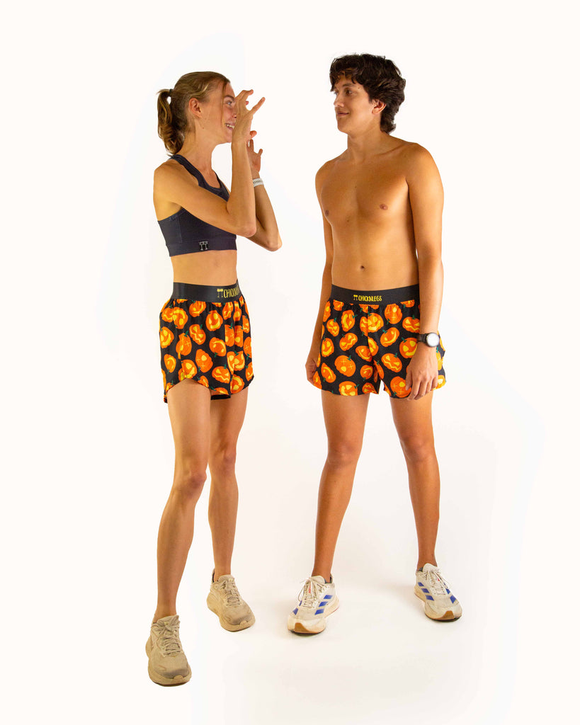 Dou image of models wearing ChicknLegs women's 4 inch split running shorts and men's 4 inch split running shorts in the Pumpkin design.