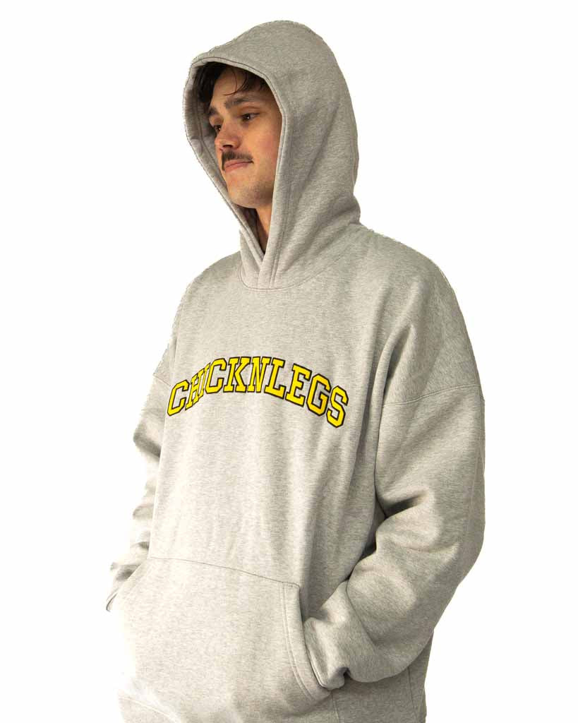 Left side view of ChicknLegs Varsity Oversized Unisex Hoodie showing the roomy oversized fit and soft midweight material.