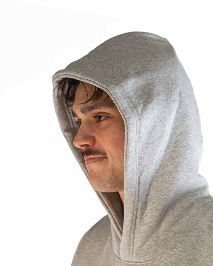 Close-up detail of ChicknLegs Varsity Oversized Unisex Hoodie with the hoodie pulled up.