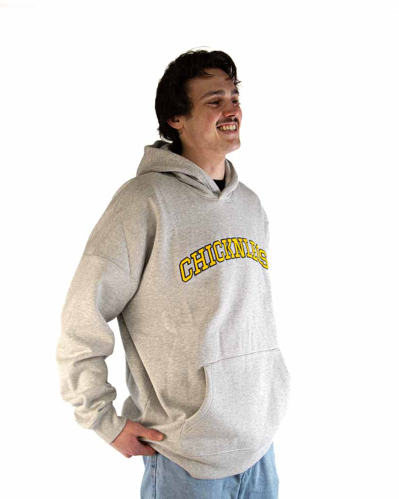 Right side view of ChicknLegs Varsity Oversized Unisex Hoodie highlighting the relaxed drop-shoulder silhouette and embroidered details.
