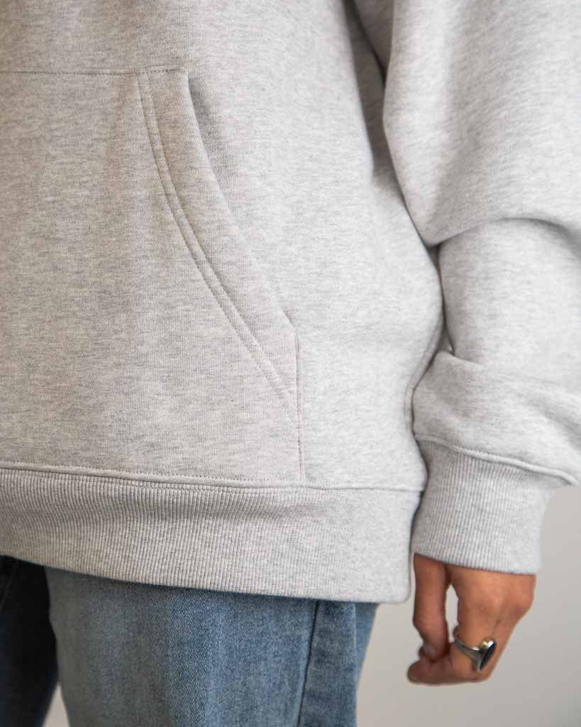 Close-up detail of ChicknLegs Varsity Oversized Unisex Hoodie fabric and construction, featuring stitching on the trims and soft midweight material.