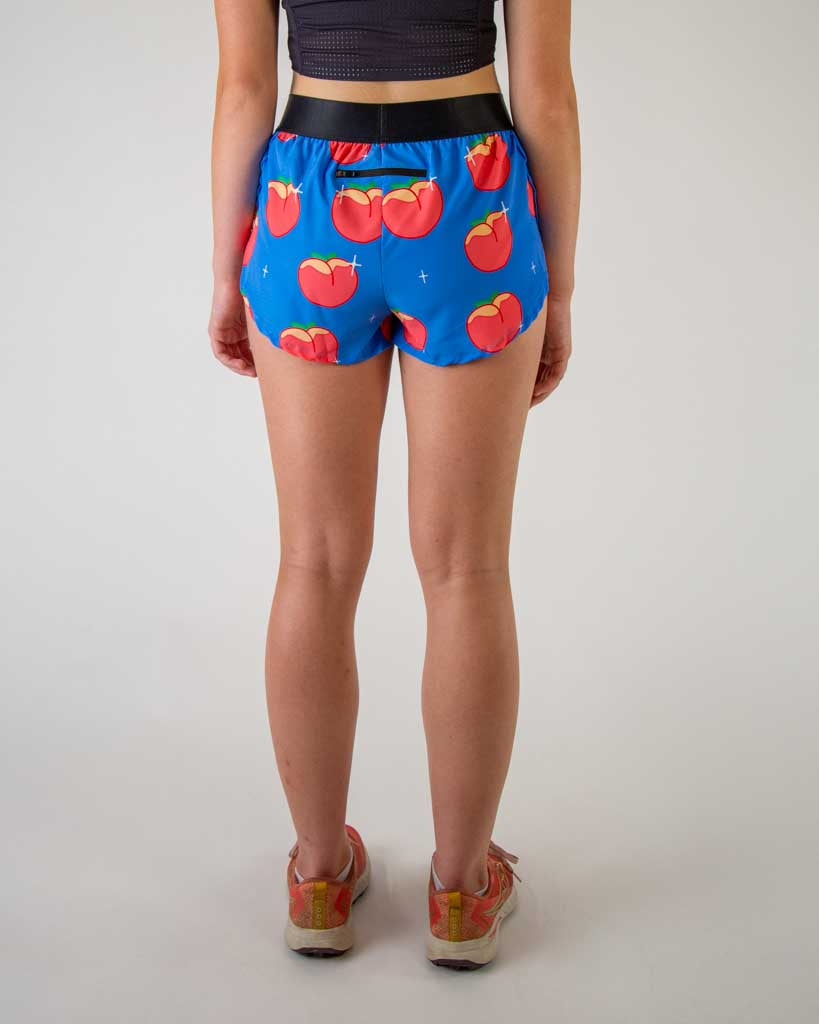 Back view of ChicknLegs women’s 1.5-inch split running shorts with drawstring, breathable liner, blue background and juicy peaches design. A back pocket is shown.