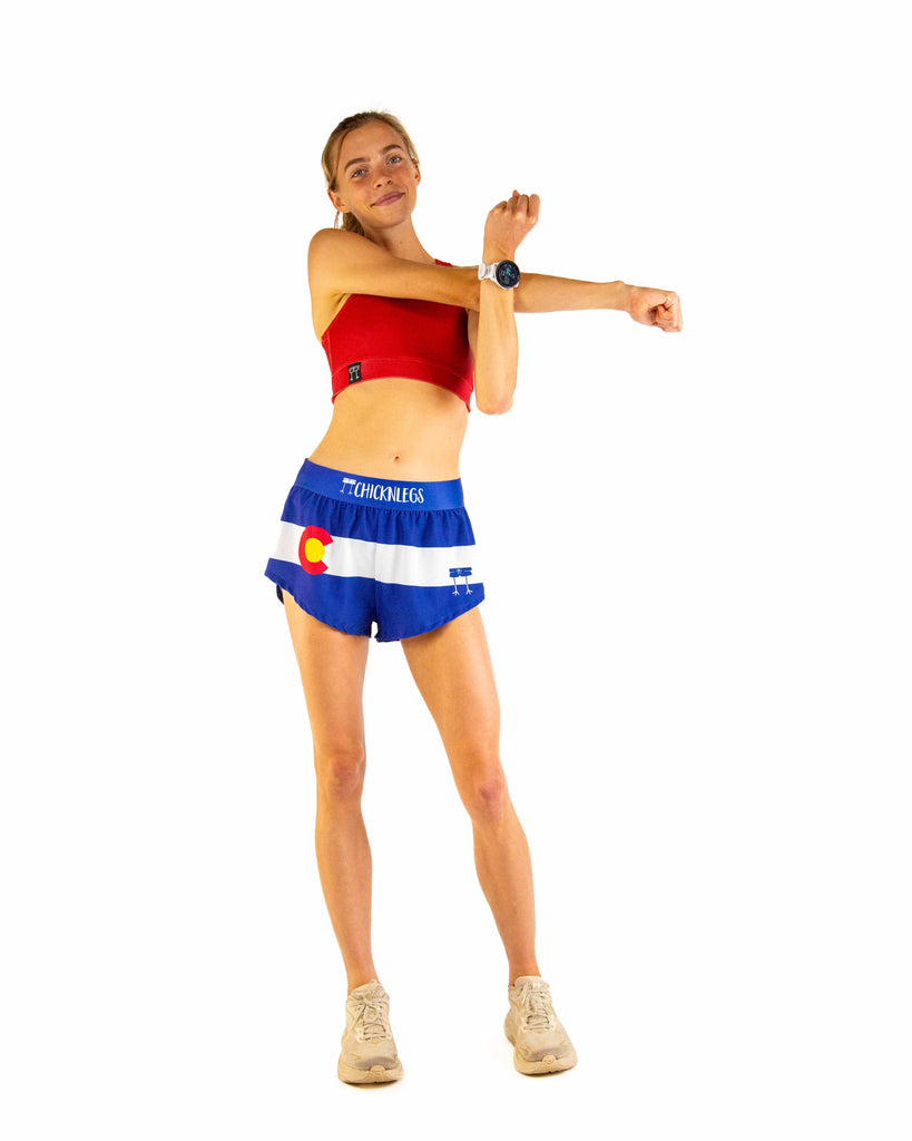 Full body view of model wearing ChicknLegs Women’s 1.5-inch split running shorts featuring a soft elastic waistband, rear zipper pocket, and black mesh liner for full coverage and breathability.