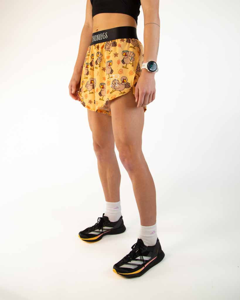 Left side view of ChicknLegs Women’s 4-inch split running shorts showing the 3-inch side split for mobility, lightweight fabric, and smooth waistband that stays in place.