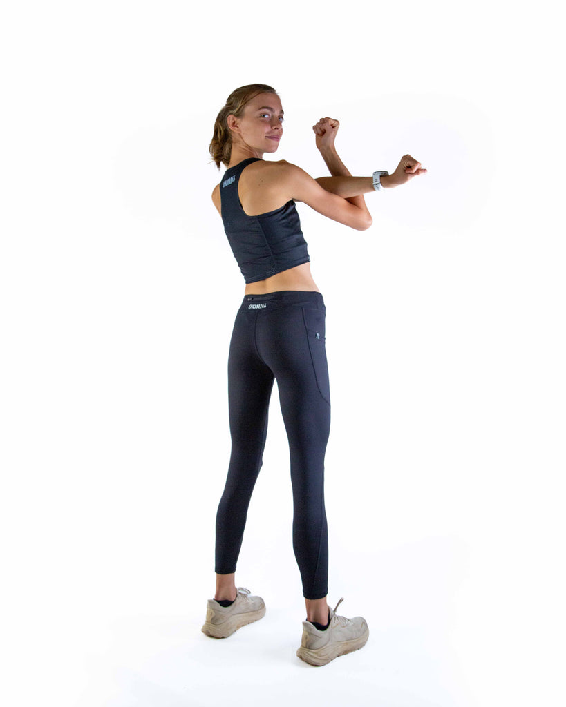 Full body view of model wearing ChicknLegs Women’s Leggings featuring a mid-rise 26-inch length, two side pockets, back zipper pocket, and buttery-soft performance fabric for comfort without chafing.