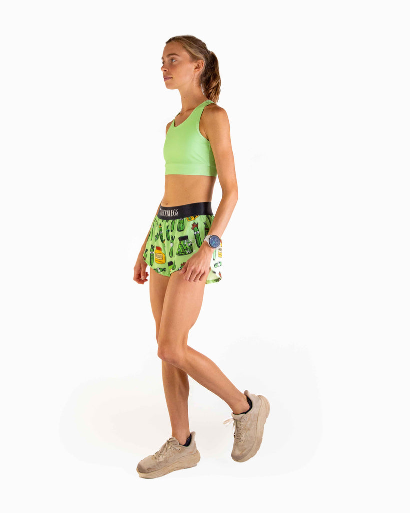 Full body view of model wearing ChicknLegs Women’s OG Sports Bra featuring lightweight fabric, seamless phone pocket, and pad-accessible design for training and racing comfort.