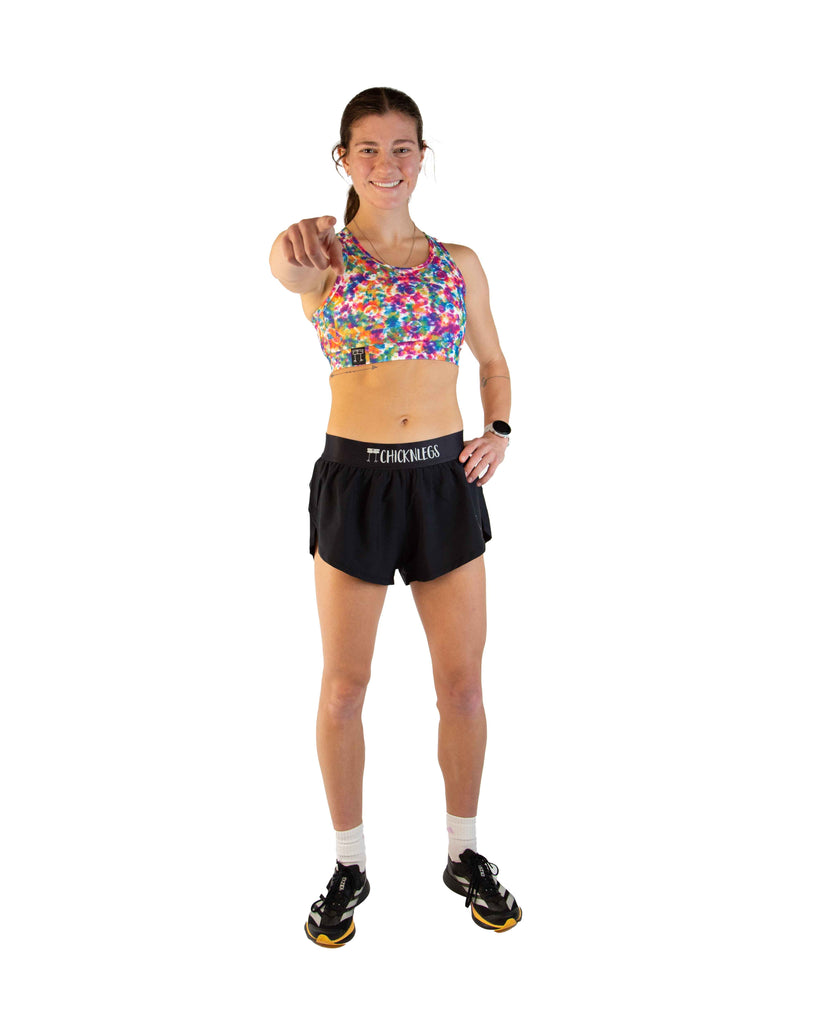 Full body view of model wearing ChicknLegs Women’s OG Sports Bra featuring lightweight fabric, seamless phone pocket, and pad-accessible design for training and racing comfort.