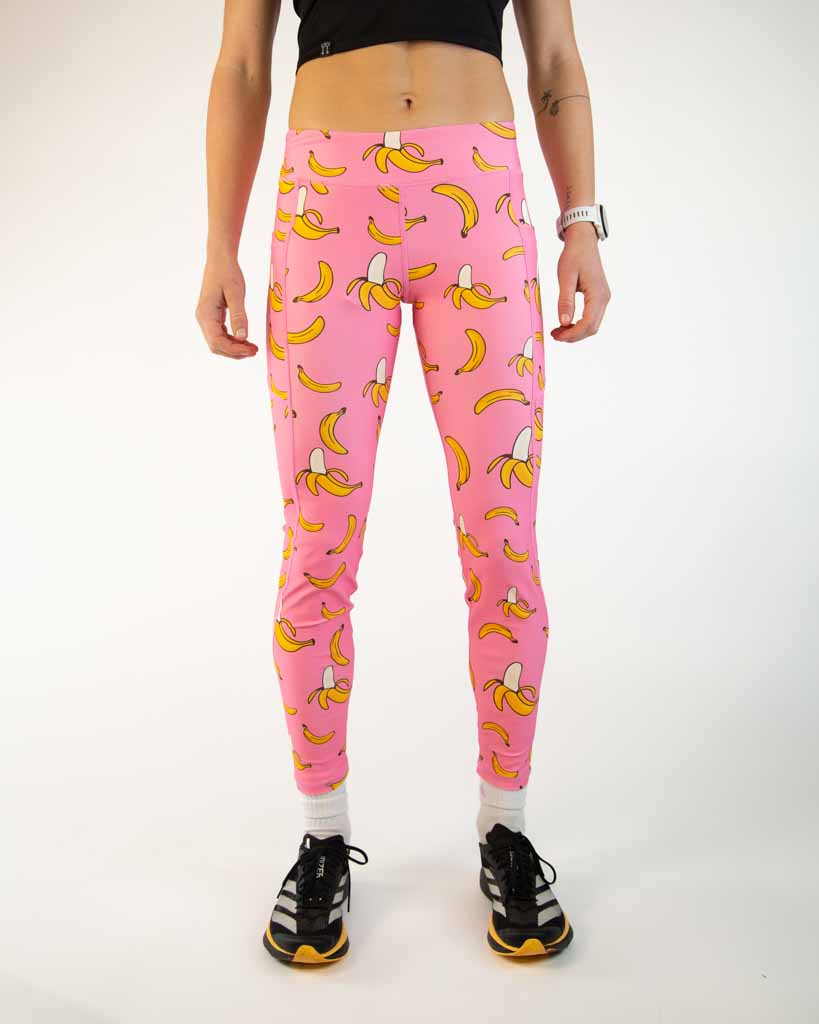 Front view of ChicknLegs Women’s Leggings in the Pink Bananas designed for running, featuring a mid-rise 26-inch length, buttery-soft performance fabric, and adjustable internal drawstring for a secure fit.
