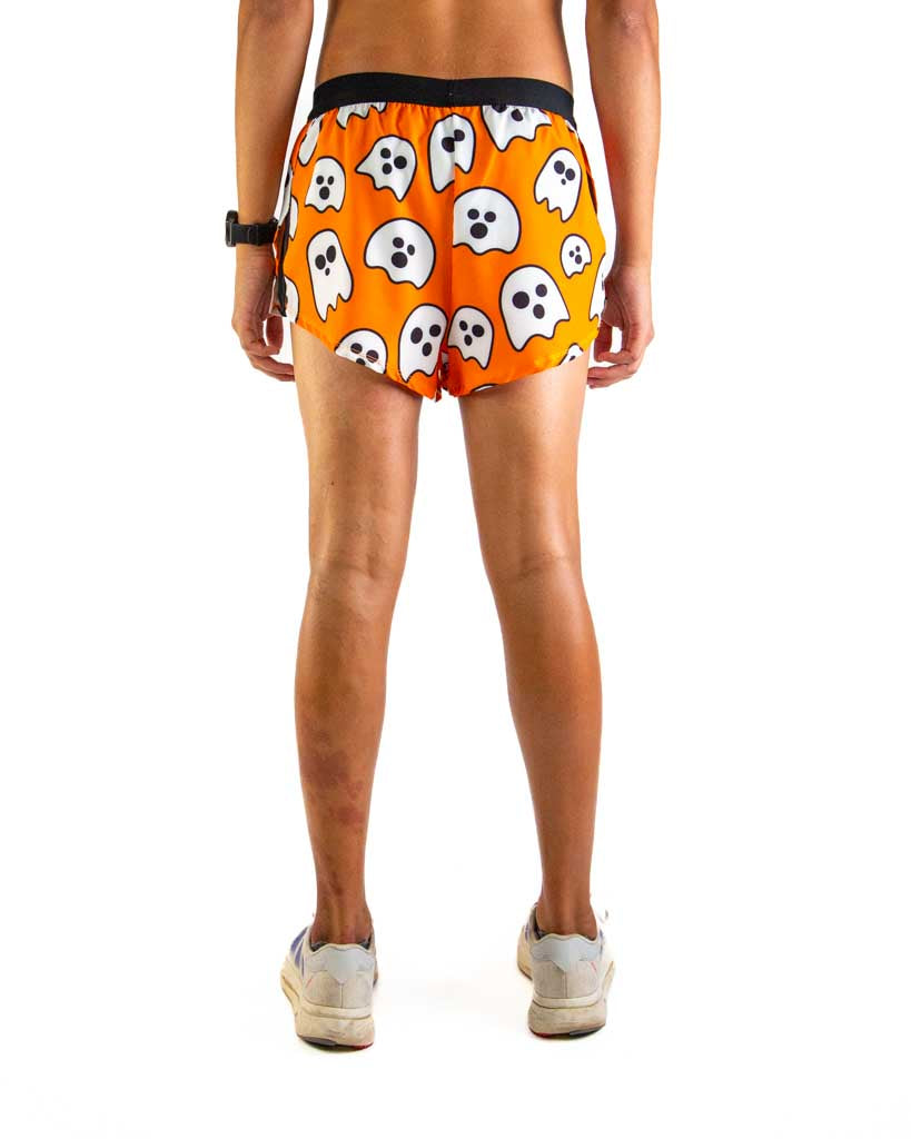 Back view of ChicknLegs men’s 2-inch split running shorts in orange with a ghost pattern, showing elastic waistband.