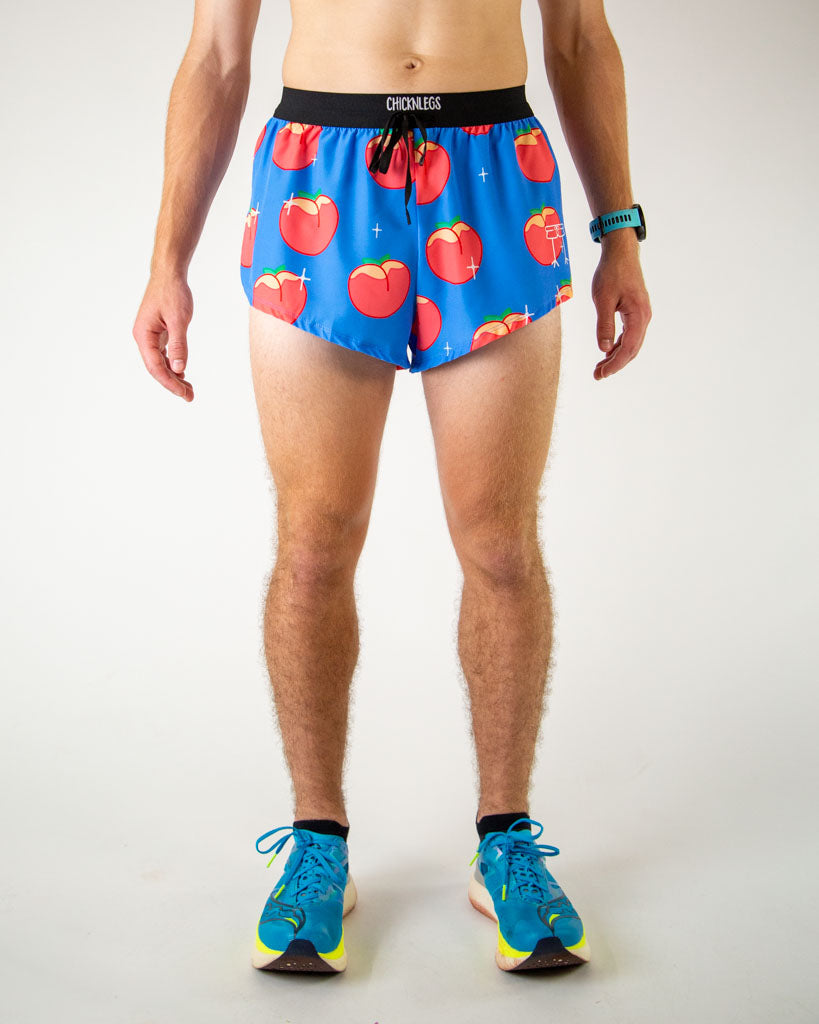 Front view of ChicknLegs men’s 2-inch split running shorts with drawstring, breathable liner, blue background and juicy peaches design.