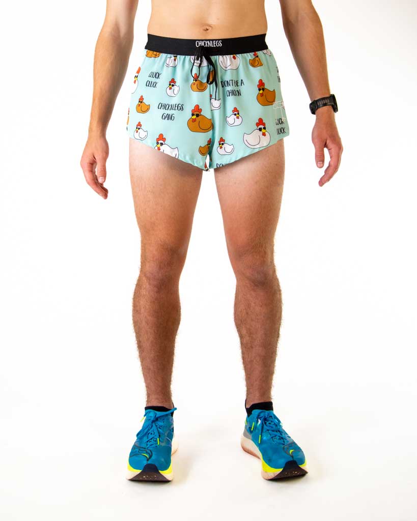 Front view of ChicknLegs men’s 2-inch split running shorts with drawstring, breathable liner, light blue background and white and brown chicken design.