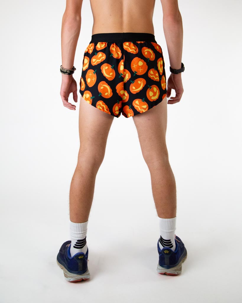 Back view of ChicknLegs men’s 2-inch split running shorts in lit up jack o lantern pattern, showing elastic waistband and breathable liner.