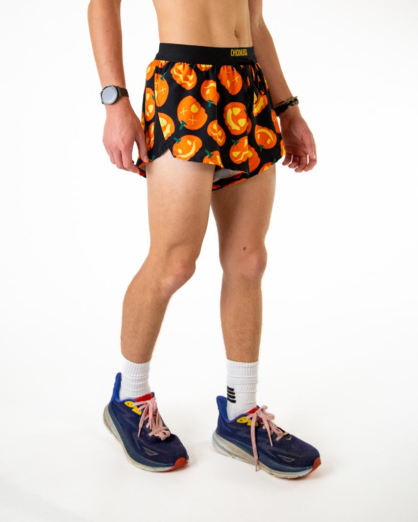 Right side view of ChicknLegs men’s 2-inch black split running shorts with orange pumpkins and black waistband.