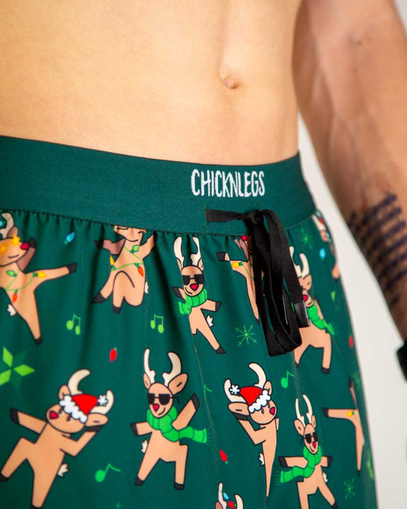 Close-up detail of ChicknLegs Men’s 2-inch DS Split Running Shorts fabric and construction, showing the dark green drawstring waistband.