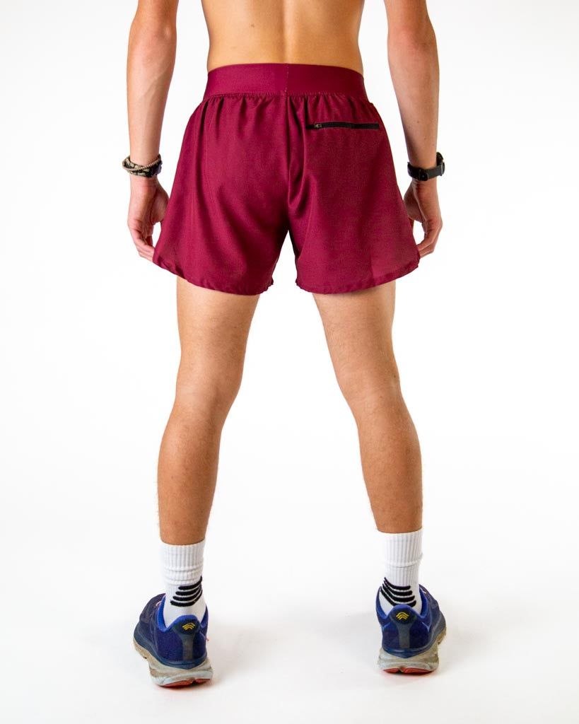 Back view of ChicknLegs men’s 4-inch split running shorts in solid maroon pattern, showing elastic waistband and breathable liner with back zipper pocket.