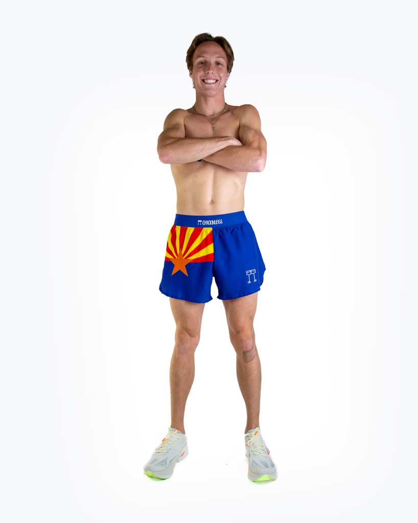Full body view of model wearing ChicknLegs men’s 4-inch split running shorts featuring a soft elastic waistband, rear zipper pocket, and black mesh liner for full coverage and breathability.
