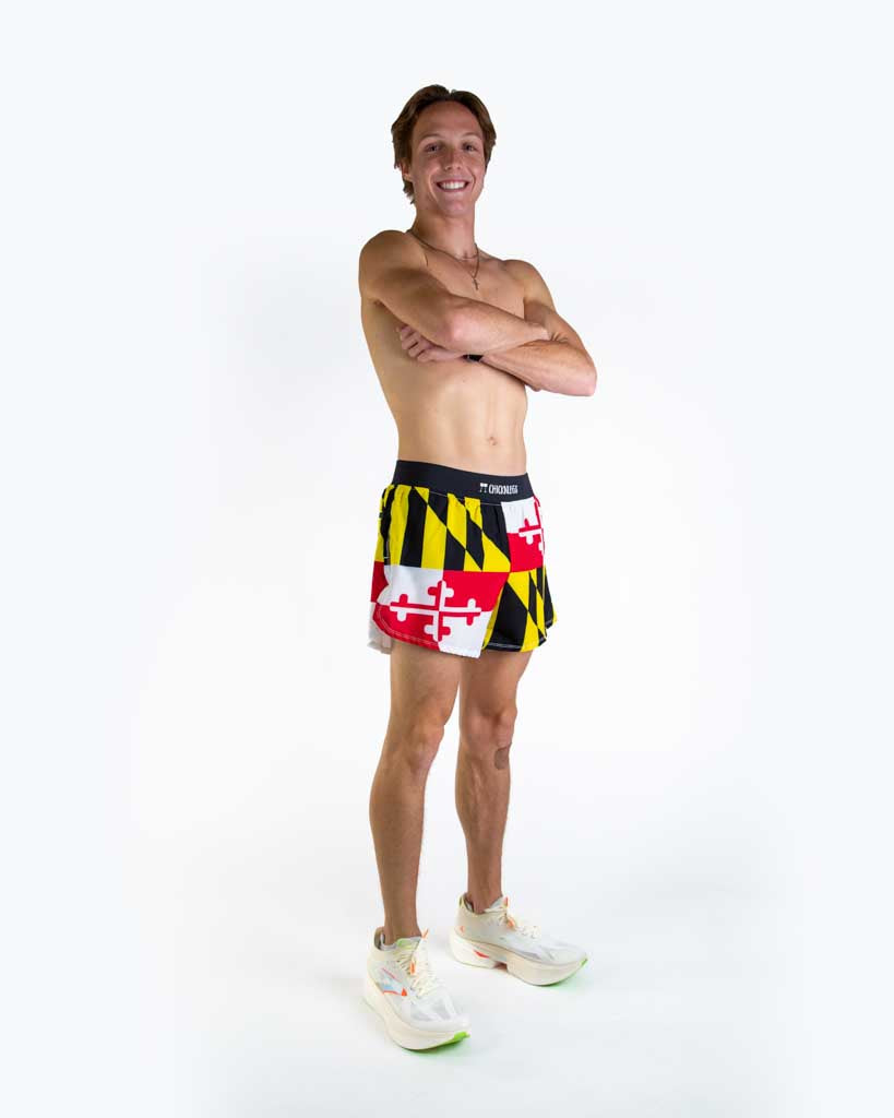 Full body view of model wearing ChicknLegs men’s 4-inch split running shorts featuring a soft elastic waistband, rear zipper pocket, and black mesh liner for full coverage and breathability. 