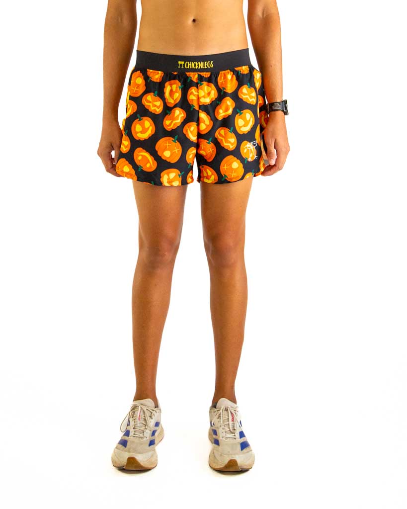 Front view of ChicknLegs men’s 4-inch split running shorts featuring a soft elastic waistband for a secure, smooth fit and black mesh liner for comfort and coverage. Featured in the design is the Pumpkins, matching with black waistband.