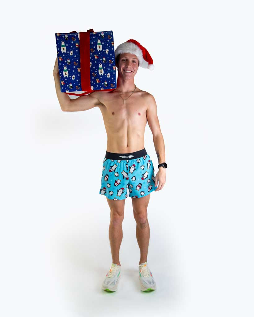 Full body view of model wearing ChicknLegs men’s 4-inch split running shorts featuring a soft elastic waistband, rear zipper pocket, and black mesh liner for full coverage and breathability.