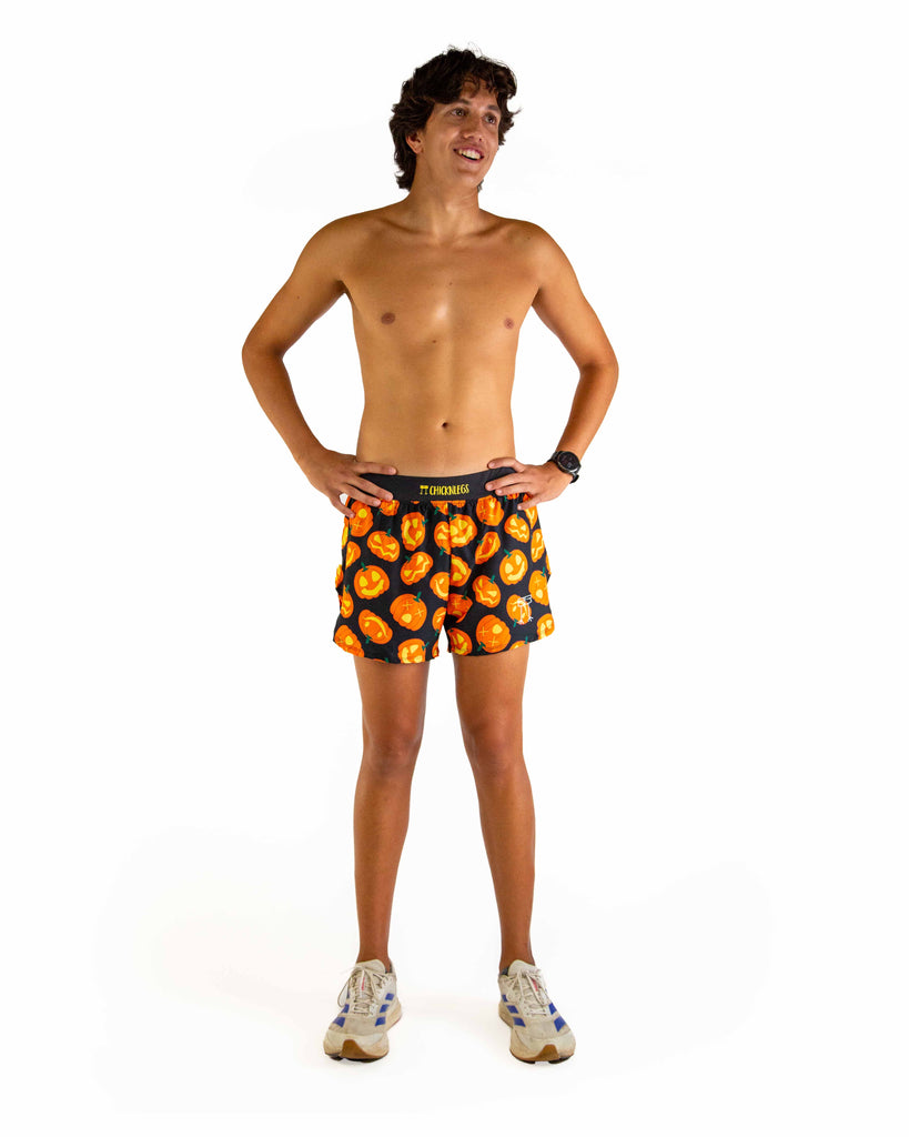 Full body view of model wearing ChicknLegs men’s 4-inch split running shorts featuring a soft elastic waistband, rear zipper pocket, and black mesh liner for full coverage and breathability.