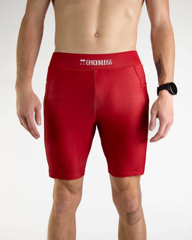 Front close up view of ChicknLegs Men’s 8-inch Half Tights featuring a soft elastic waistband for a smooth, secure fit and black mesh liner for support and comfort. Featured are the Cardinal Red solid color!