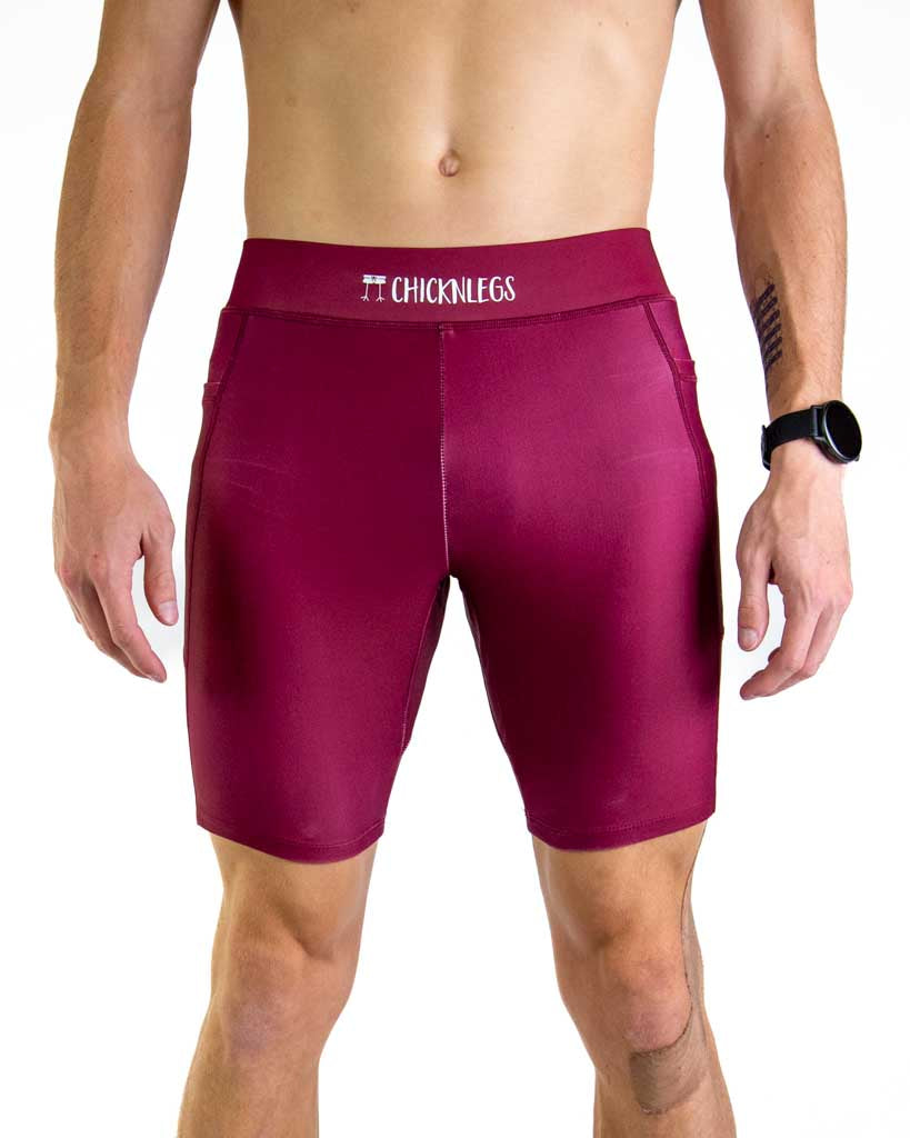 Front close up view of ChicknLegs Men’s 8-inch Half Tights featuring a soft elastic waistband for a smooth, secure fit and black mesh liner for support and comfort. Featured are the Maroon solid color!