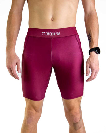 Front close up view of ChicknLegs Men’s 8-inch Half Tights featuring a soft elastic waistband for a smooth, secure fit and black mesh liner for support and comfort. Featured are the Maroon solid color!