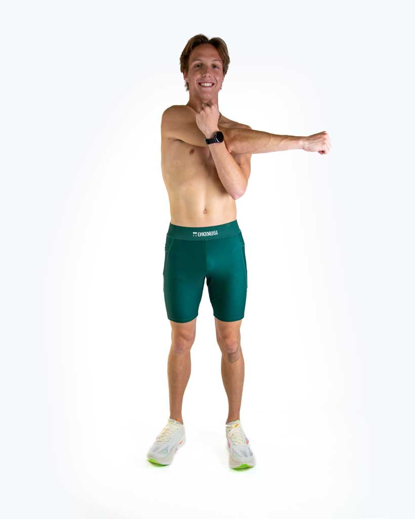Full body view of model wearing ChicknLegs Men’s 8-inch Half Tights with soft elastic waistband, dual side pockets, internal key pocket, and black mesh liner for support and chafe-free performance.
