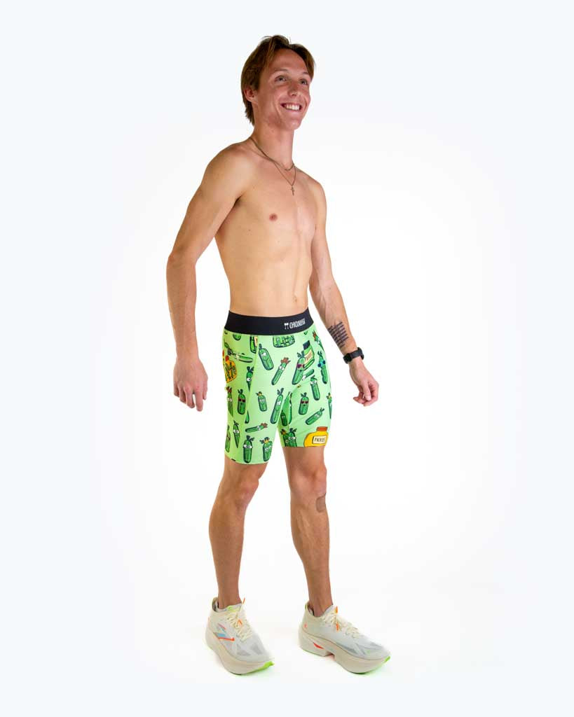 Full body view of model wearing ChicknLegs Men’s 8-inch Half Tights with soft elastic waistband, dual side pockets, internal key pocket, and black mesh liner for support and chafe-free performance.