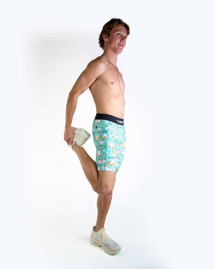 Full body view of model wearing ChicknLegs Men’s 8-inch Half Tights with soft elastic waistband, dual side pockets, internal key pocket, and black mesh liner for support and chafe-free performance.