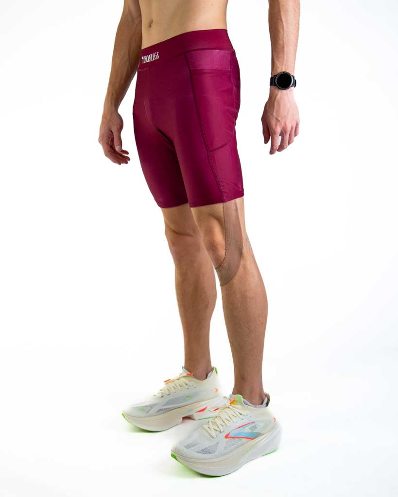 Left side view of ChicknLegs Men’s 8-inch Half Tights showing the streamlined fit, side pocket for essentials, and lightweight stretch fabric designed for performance.