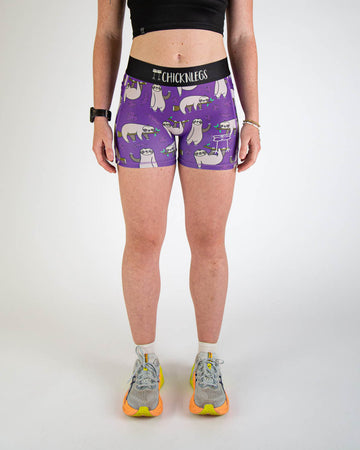 Front view of ChicknLegs women’s 3-inch compression spandex running shorts, purple background and sloths all over.