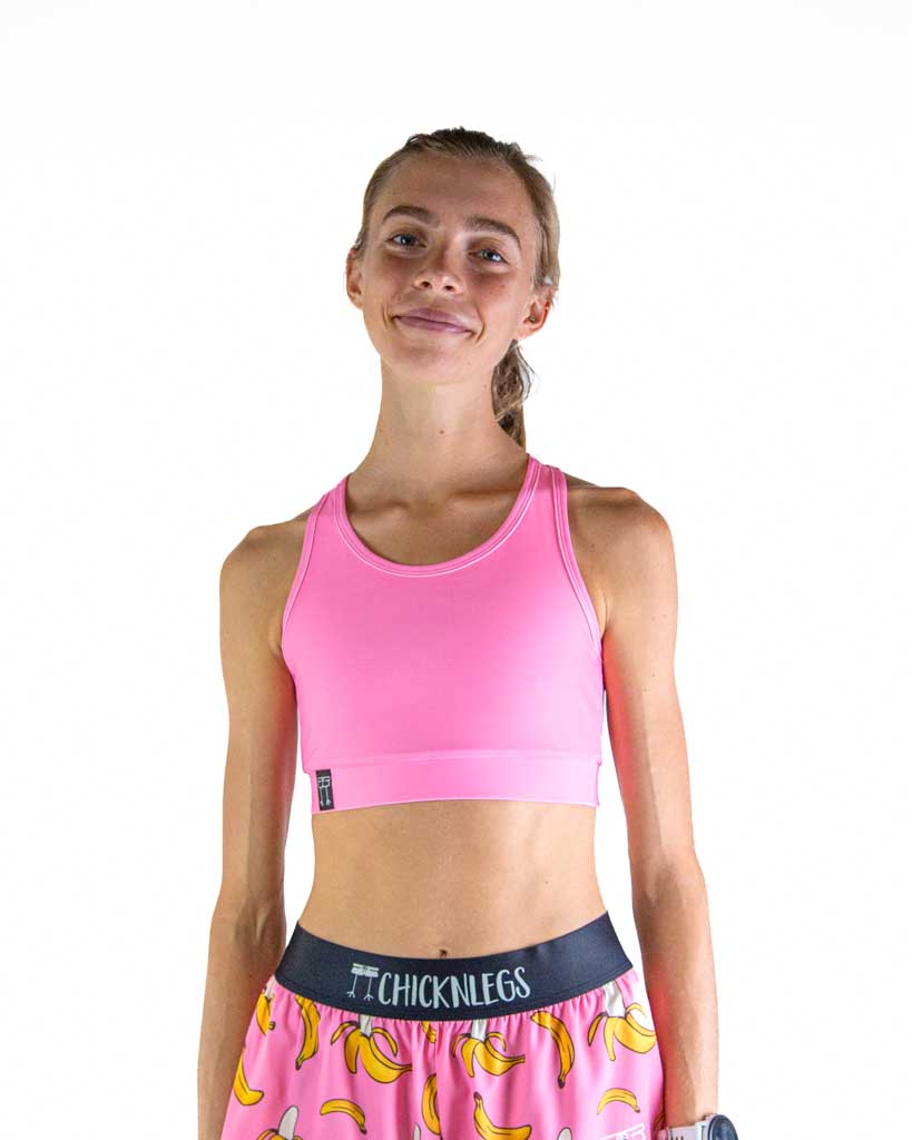 Front view of ChicknLegs Women’s OG Sports Bra featuring lightweight fabric perfect for training and racing, with a sleek, supportive fit in the Bubblegum Pink design.