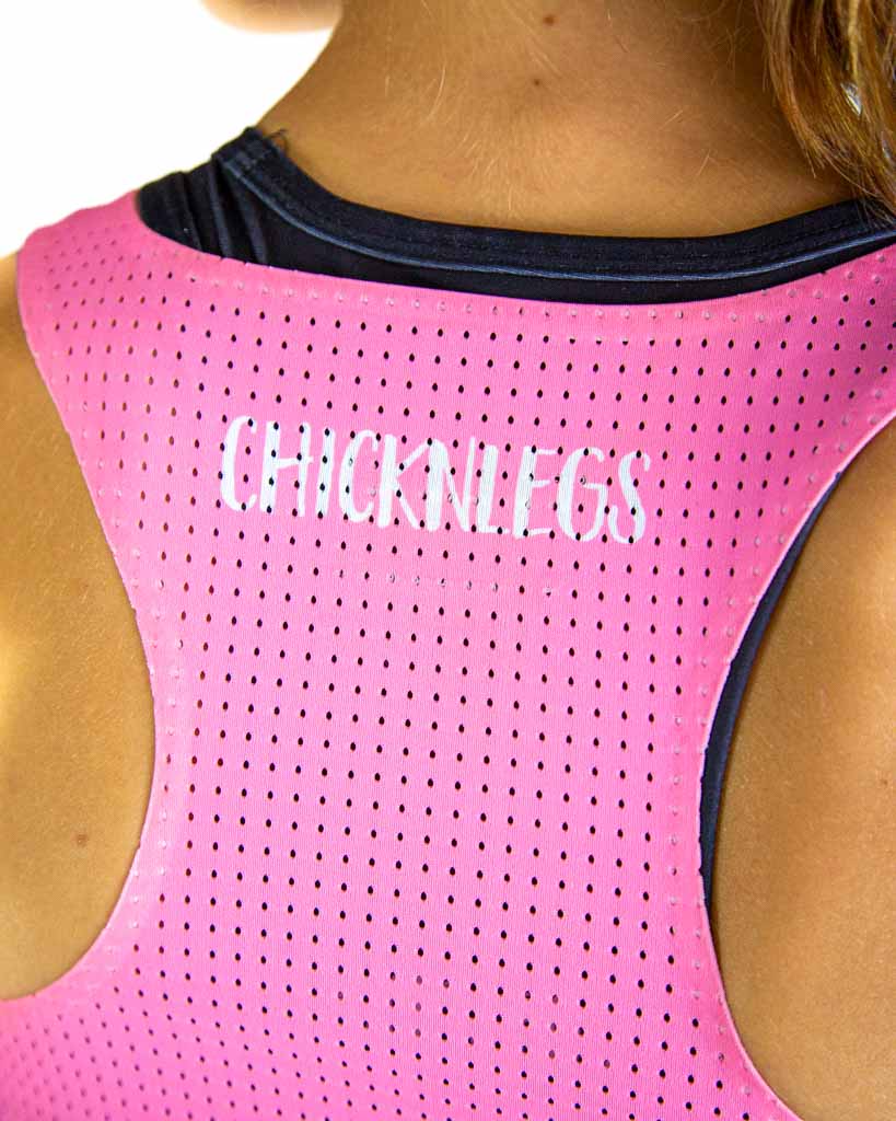 Close-up detail of ChicknLegs Women’s PWR Crop Top fabric, showing the mesh back texture, seamless stitching, and smooth lightweight material in bubblegum pink.