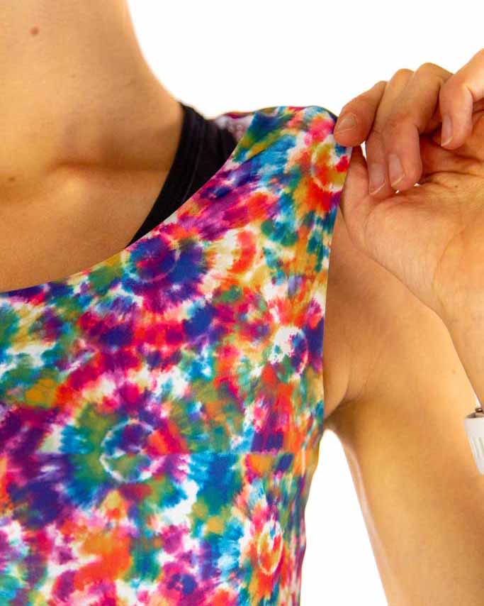 A close up image is shown of the runner pulling at the pwr crop top. Showing the lightweight fabric between the product of the crop and the sports bra.