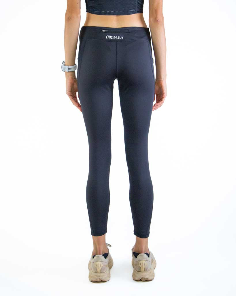 Back view of ChicknLegs Women’s Leggings showcasing the back zipper pocket for storage, mid-rise waistband with adjustable drawstring, and 26-inch length for a supportive running fit.