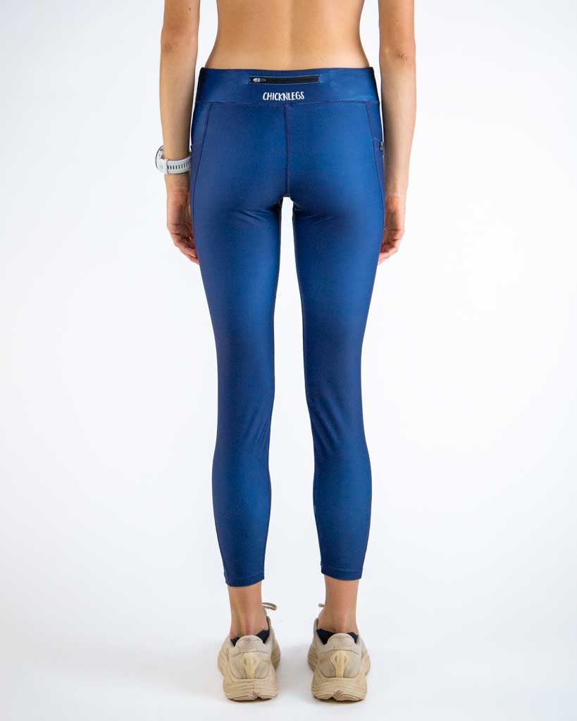Back view of ChicknLegs Women’s Navy Leggings showcasing the back zipper pocket for storage, mid-rise waistband with adjustable drawstring, and 26-inch length for a supportive running fit.